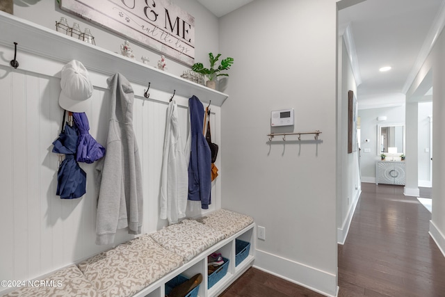 mudroom with ornamental molding and dark hardwood / wood-style flooring