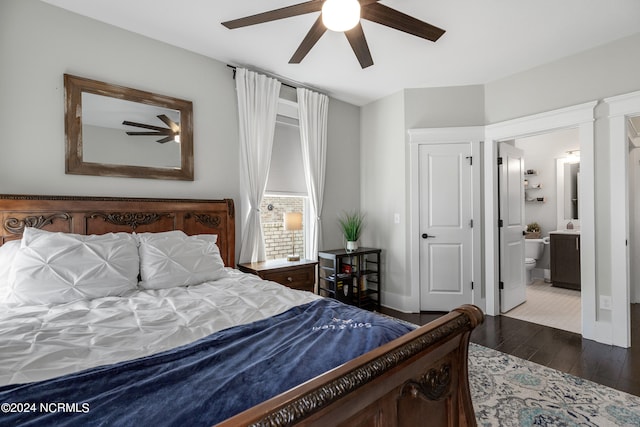 bedroom featuring connected bathroom, dark wood-type flooring, and ceiling fan