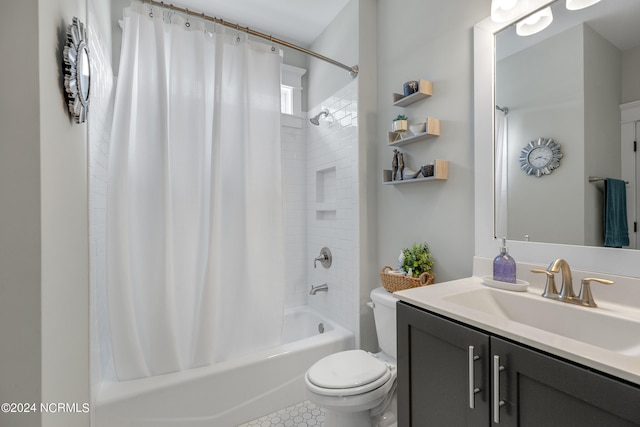 full bathroom with vanity, shower / bath combo with shower curtain, and toilet