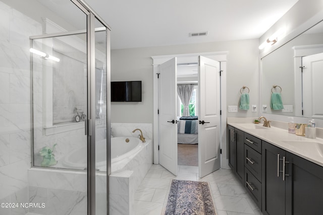 bathroom with vanity and separate shower and tub