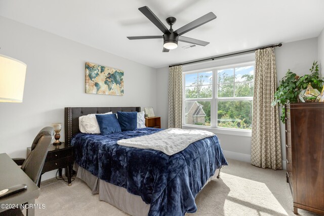 bedroom featuring light carpet and ceiling fan