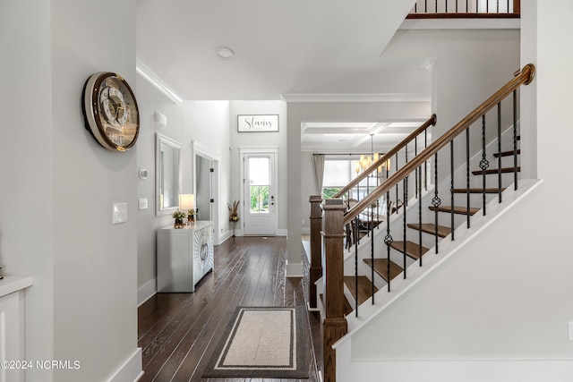 entryway with dark wood-type flooring and a notable chandelier