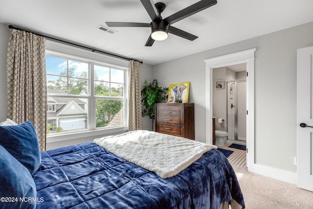 bedroom featuring carpet floors, ceiling fan, and ensuite bathroom