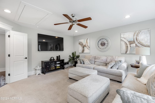 carpeted living room with ceiling fan