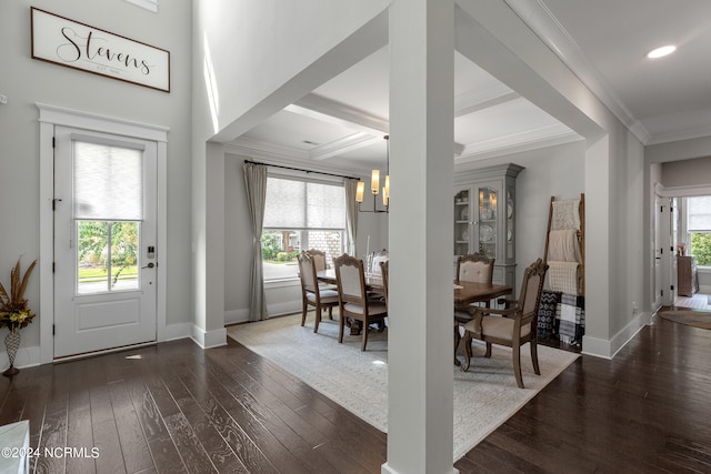 foyer entrance featuring beamed ceiling, dark hardwood / wood-style floors, a chandelier, and a wealth of natural light