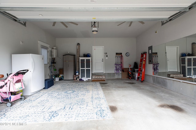 garage with a garage door opener, electric panel, ceiling fan, and white refrigerator