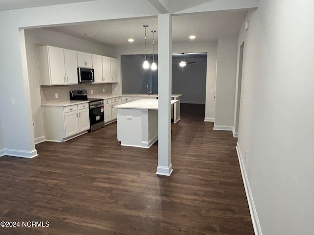 kitchen featuring pendant lighting, dark hardwood / wood-style floors, appliances with stainless steel finishes, and white cabinets