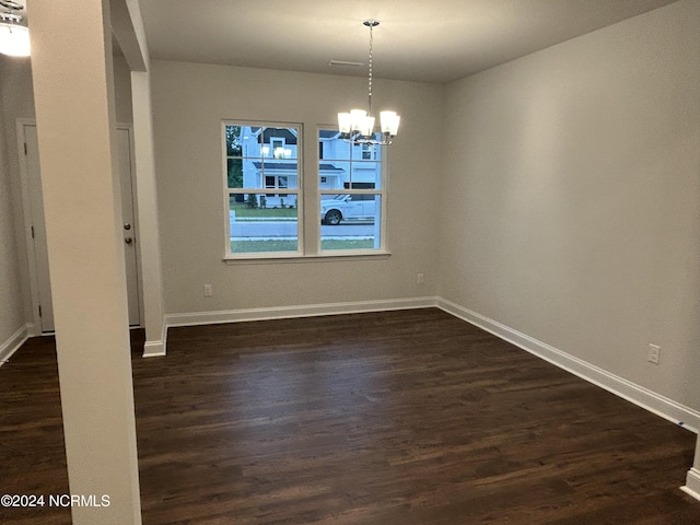 200 Flora Field Dr, Jacksonville, NC 28546 - unfurnished dining area with dark wood-type flooring, an inviting chandelier, and baseboards