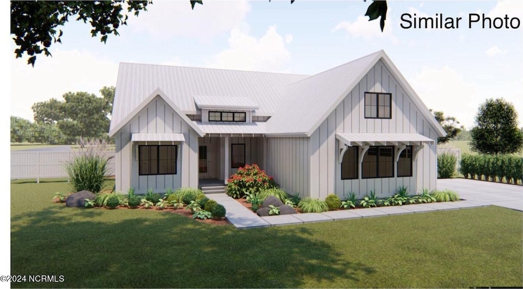 modern farmhouse featuring a front yard