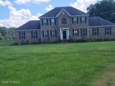 colonial-style house with a front yard