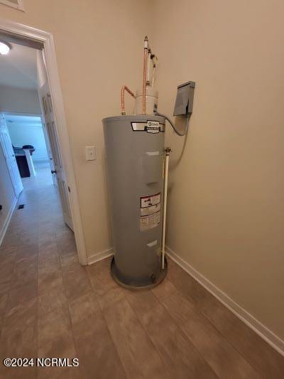 utility room featuring water heater