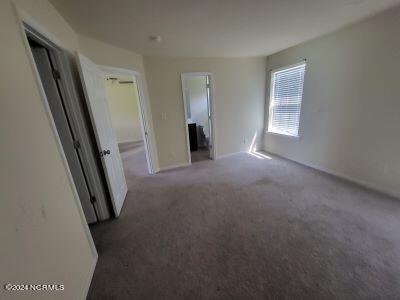 unfurnished bedroom featuring dark colored carpet