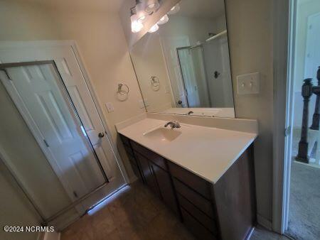 bathroom with an enclosed shower and vanity