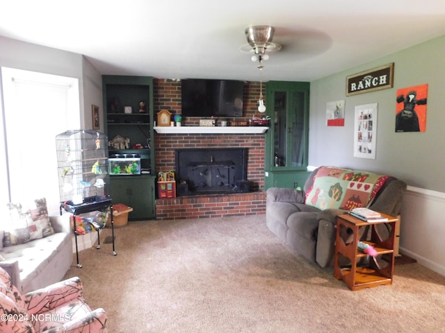 living room featuring carpet, plenty of natural light, ceiling fan, and a brick fireplace