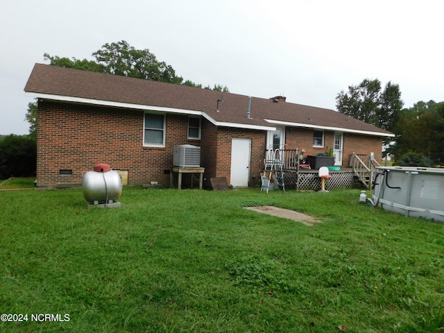 back of house with central AC unit, a lawn, and a swimming pool side deck