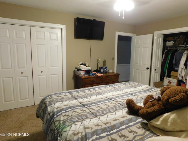 bedroom featuring two closets and carpet flooring