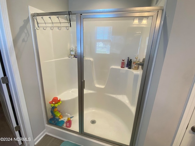 bathroom with walk in shower and tile patterned floors