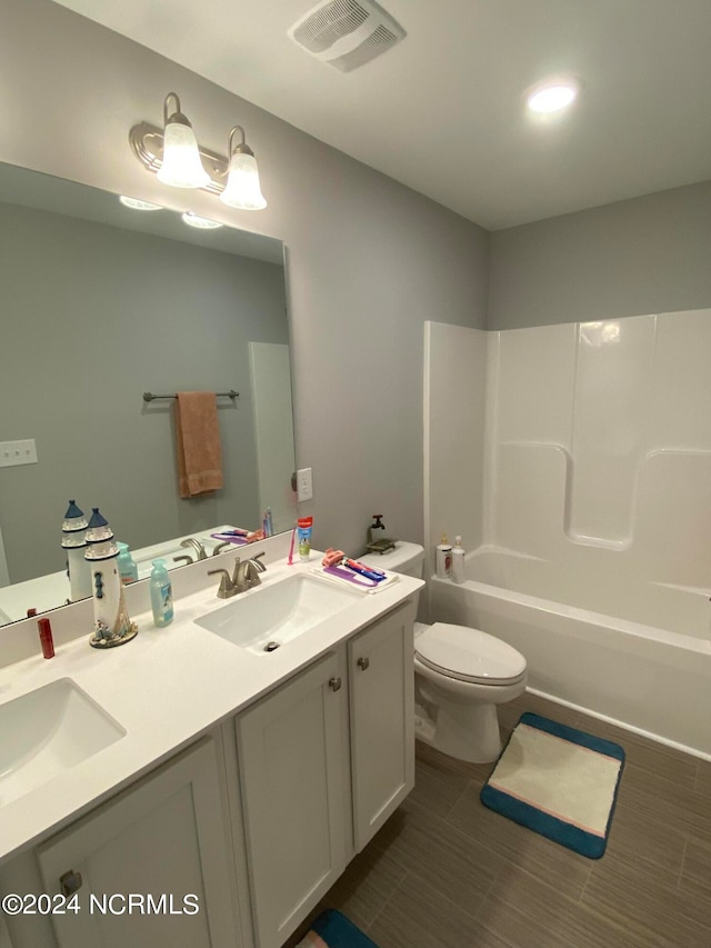 full bathroom with washtub / shower combination, vanity, and toilet