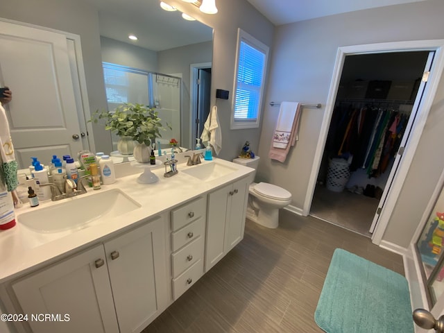 bathroom with vanity, toilet, and an enclosed shower