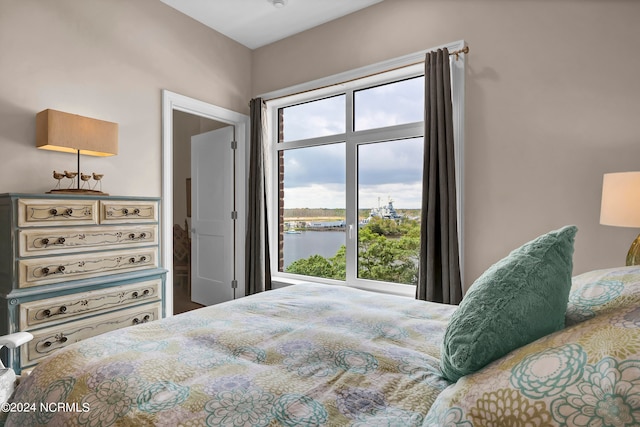 bedroom featuring a water view