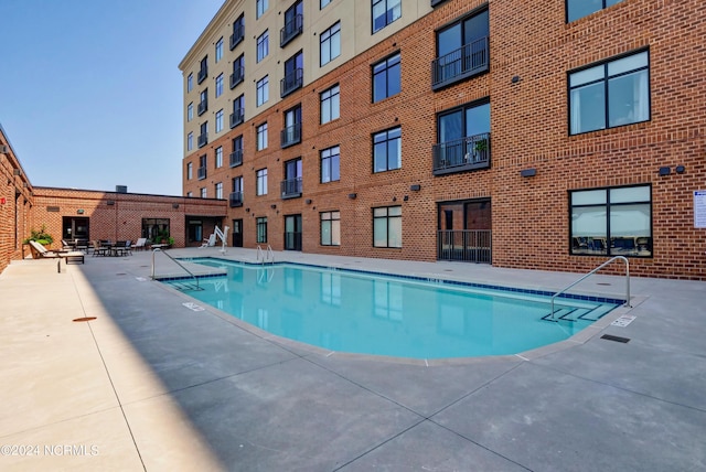 view of swimming pool with a patio area