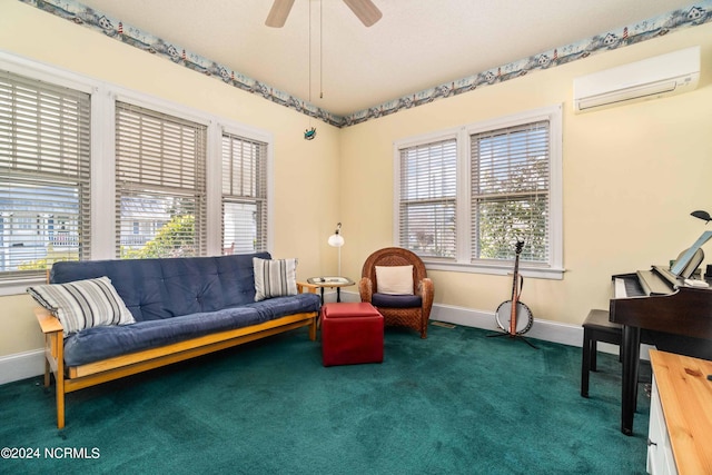 sitting room featuring dark colored carpet, a wall unit AC, and ceiling fan