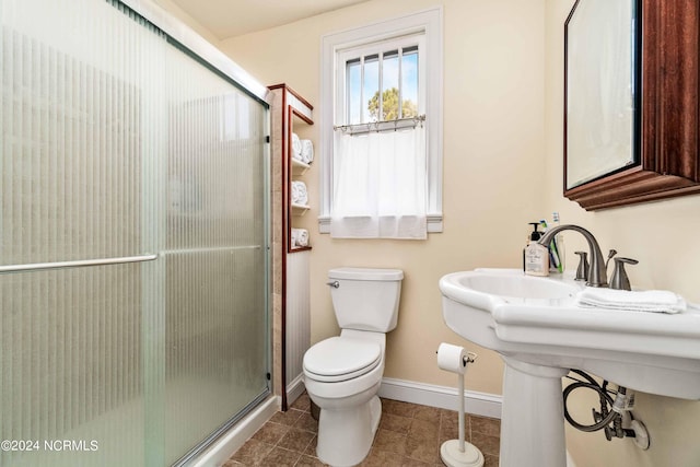 bathroom with walk in shower, tile patterned flooring, and toilet