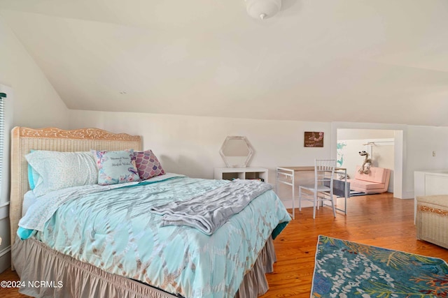 bedroom with lofted ceiling and hardwood / wood-style flooring