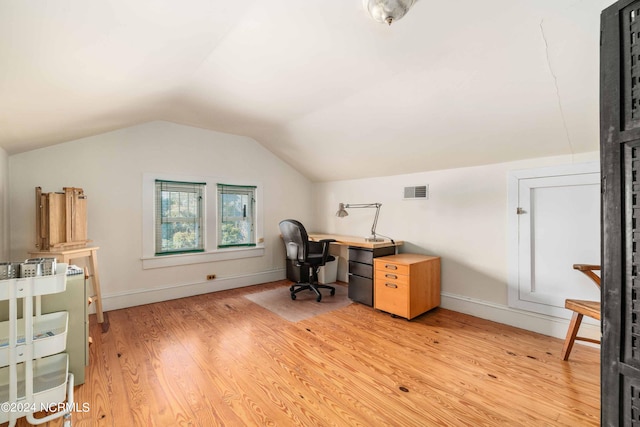 office featuring vaulted ceiling and light hardwood / wood-style floors