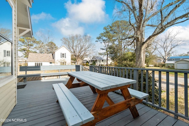 deck with an outdoor structure and a garage