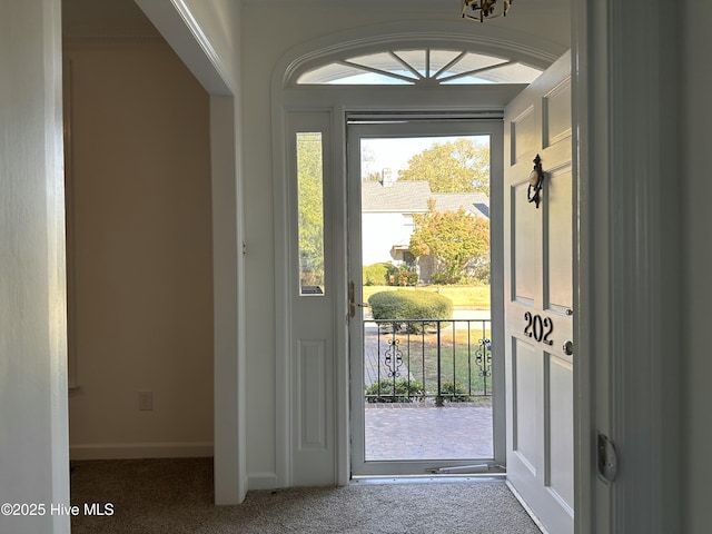 doorway to outside with carpet floors