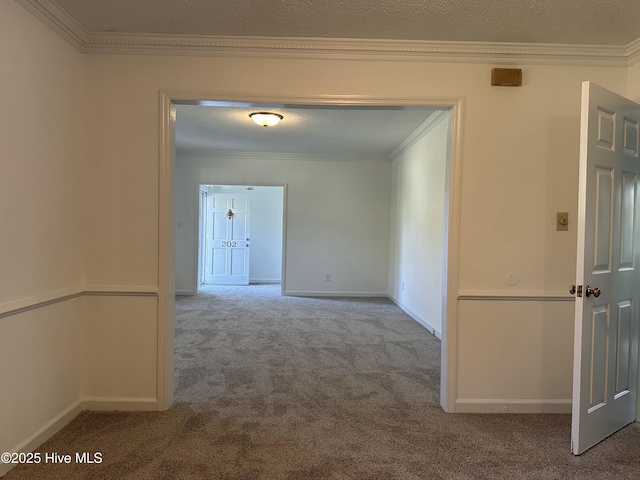 corridor with crown molding, carpet floors, and a textured ceiling