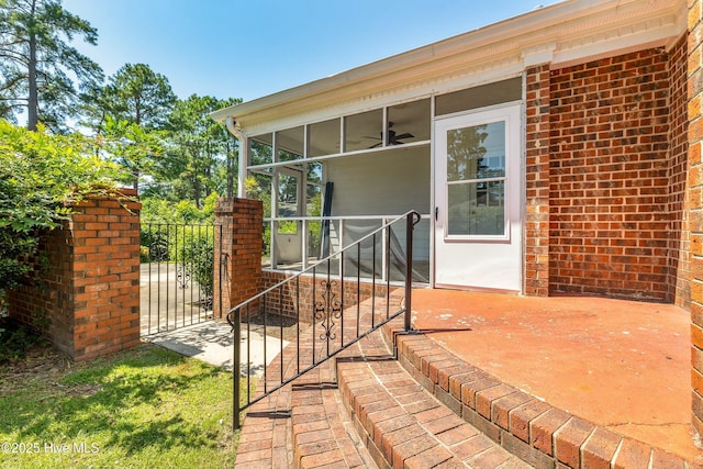 property entrance with ceiling fan and a patio