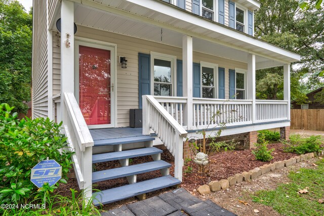 view of exterior entry featuring a porch