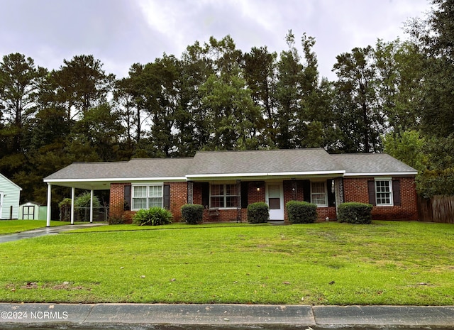 ranch-style home featuring a carport and a front lawn