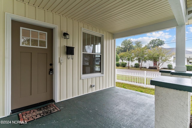 view of exterior entry featuring a porch