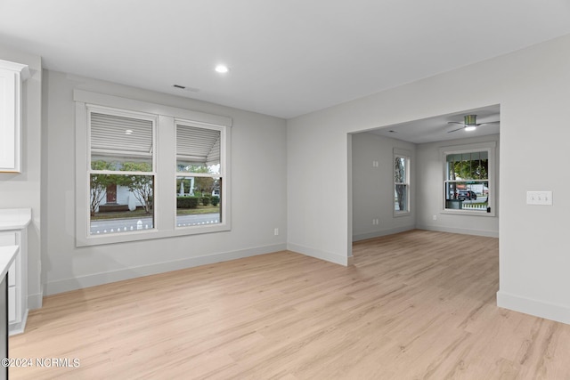 unfurnished living room with ceiling fan and light hardwood / wood-style floors