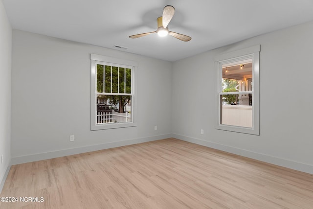 spare room featuring ceiling fan and light hardwood / wood-style flooring