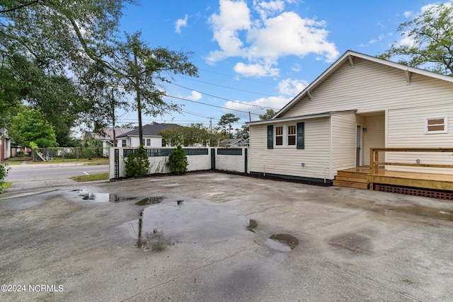 view of side of property featuring a wooden deck