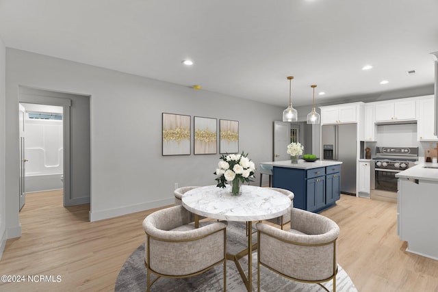 dining space with light wood-type flooring