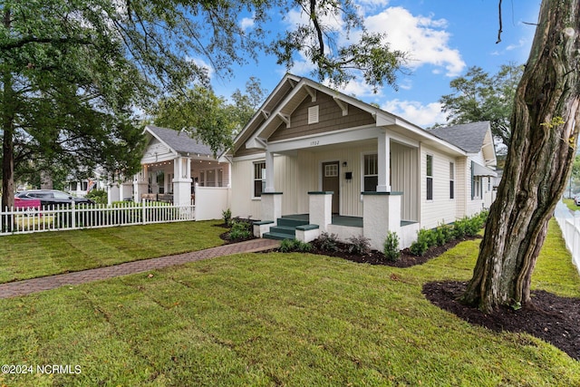 view of front of home featuring a front yard and a porch