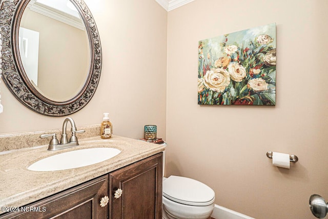 bathroom with crown molding, vanity, and toilet