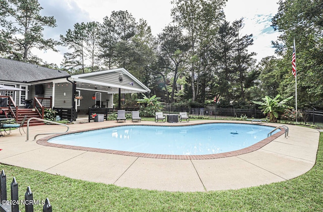 view of pool featuring a diving board and a patio area