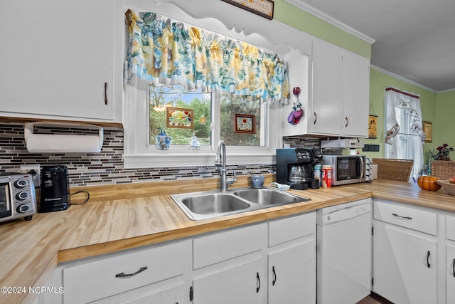 kitchen featuring ornamental molding, sink, tasteful backsplash, white cabinetry, and dishwasher