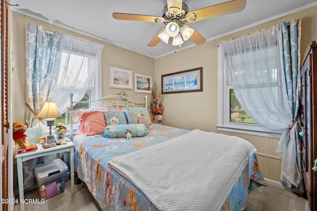 bedroom featuring a textured ceiling, crown molding, and ceiling fan