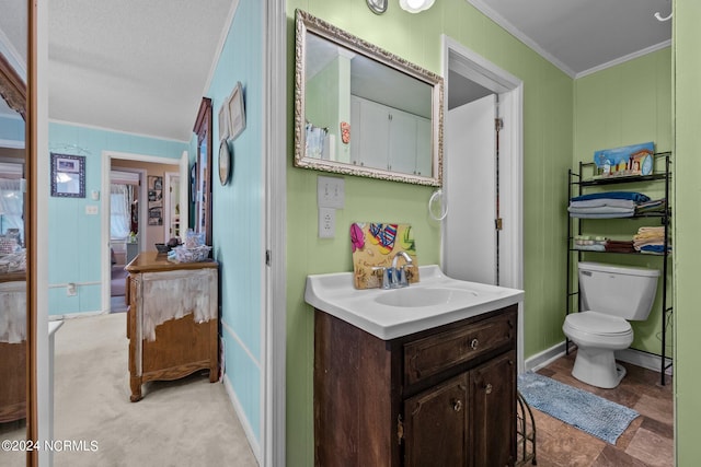 bathroom with ornamental molding, a textured ceiling, vanity, and toilet