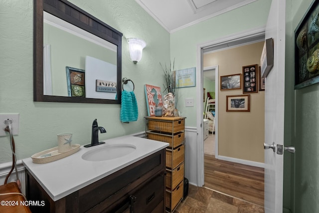 bathroom featuring ornamental molding, wood-type flooring, and vanity