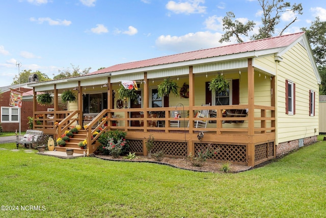 rear view of house featuring a yard