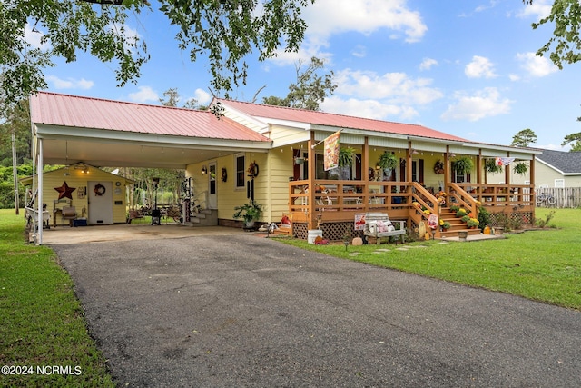 view of front of property with a carport, a porch, and a front yard