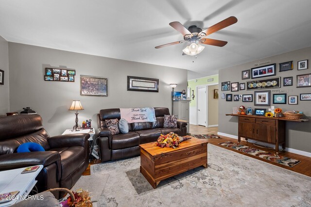 living room with light wood-type flooring and ceiling fan